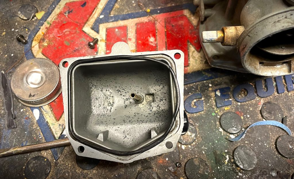 motorcycle carburetor on a workbench