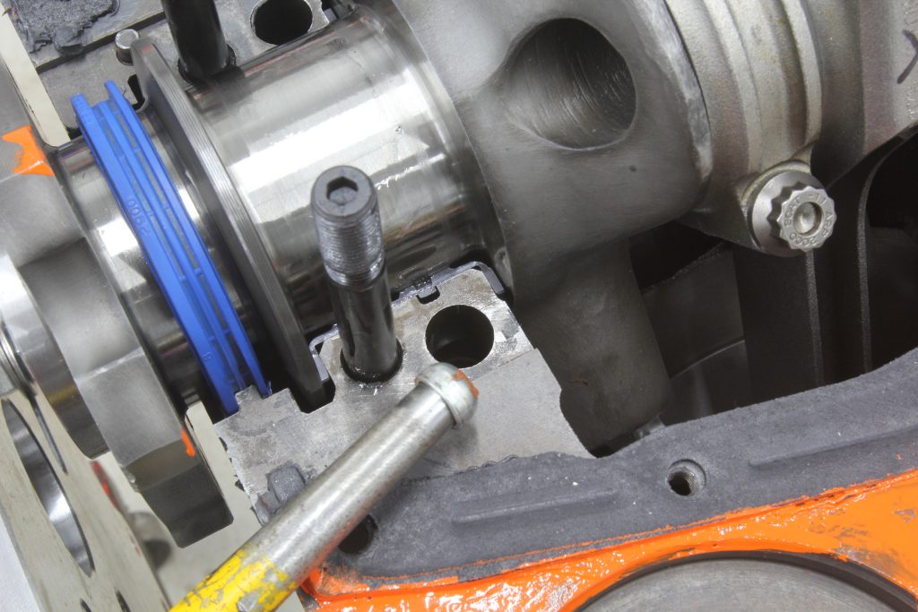 stud and port near crankshaft in an engine block