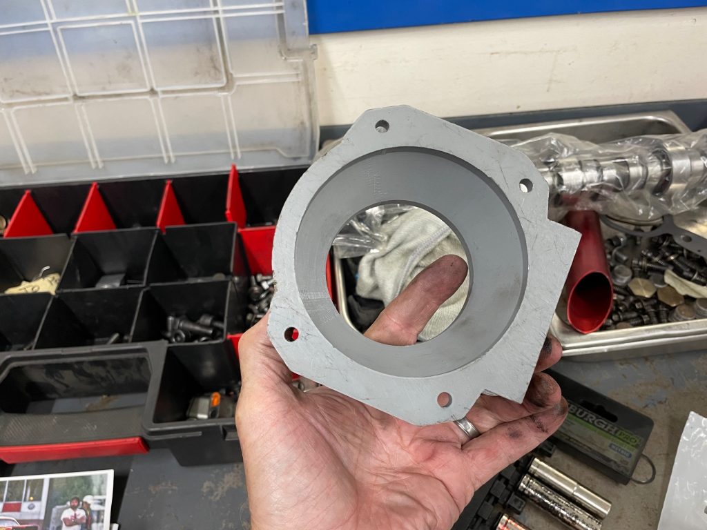 man holding throttle body adapter