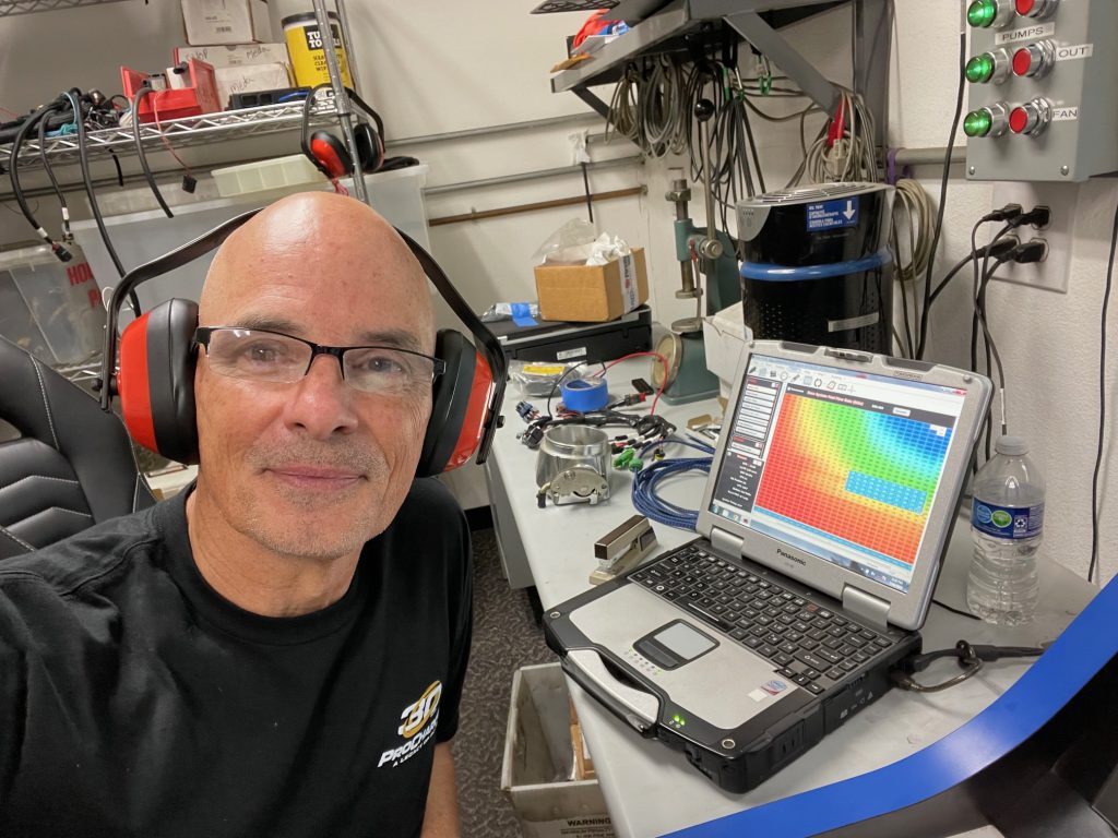 man at laptop adjusting engine tuning software