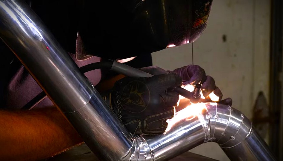 welder fabbing up an exhaust bend