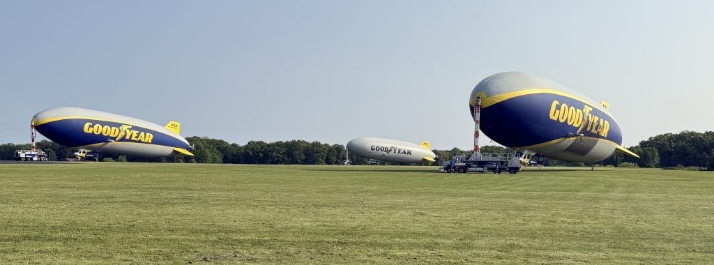 3 Goodyear blimps docked at airfield