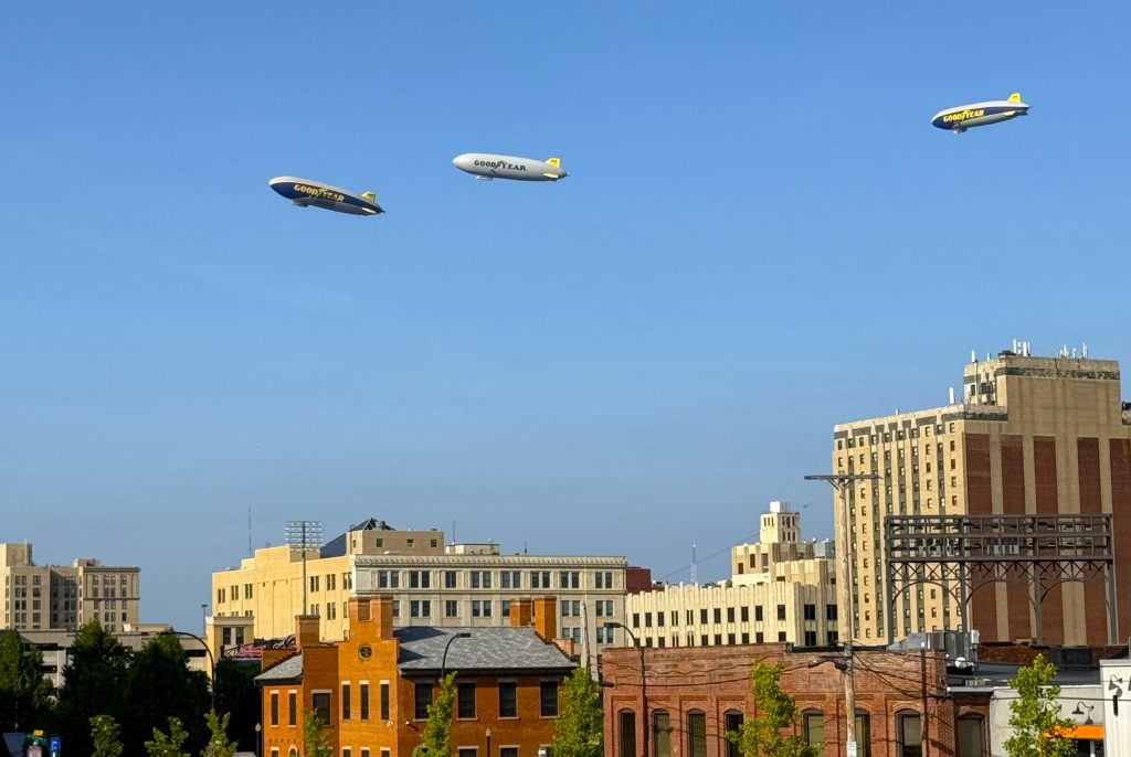 3 goodyear blimps aloft over the city of Akron, Ohio