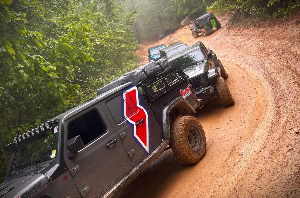 jeeps lined up along a muddy trail