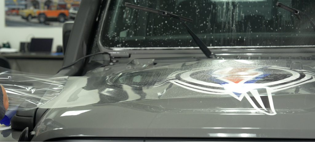 clear plastic windshield film applied on a Jeep