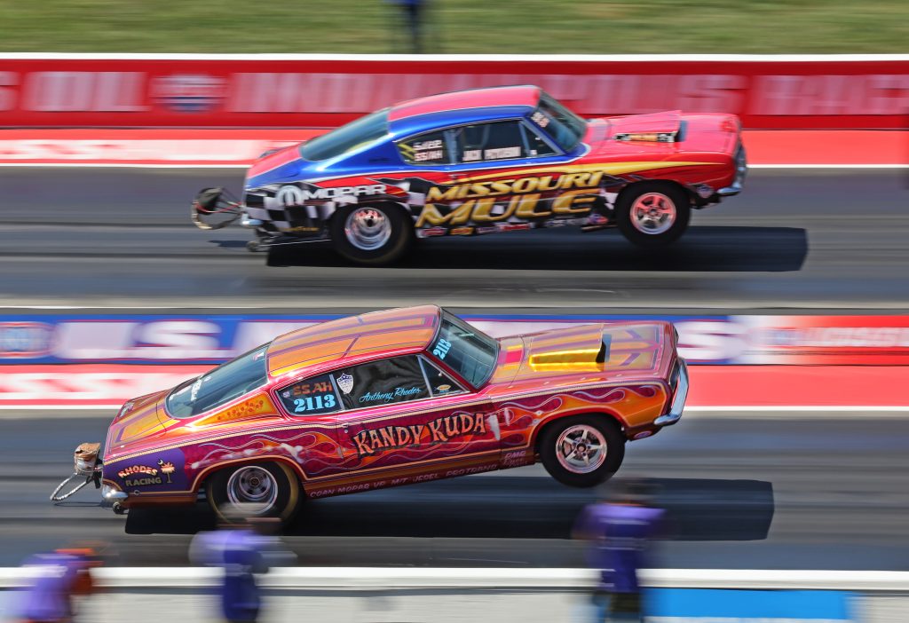 a pair of vintage mopar drag cars on track