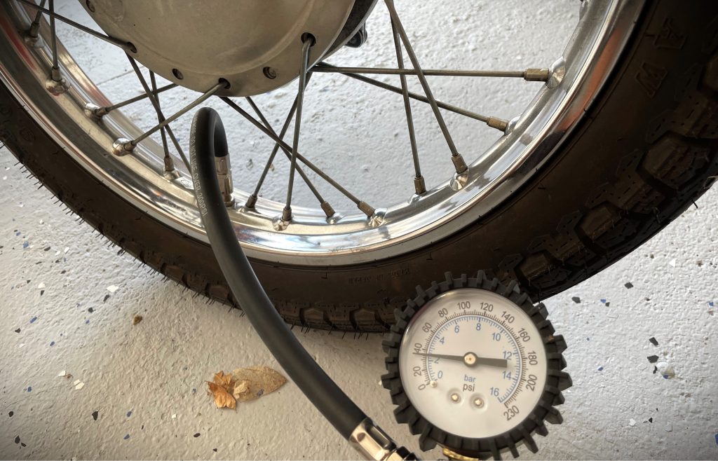 inflating a tire on a spoke motorcycle wheel