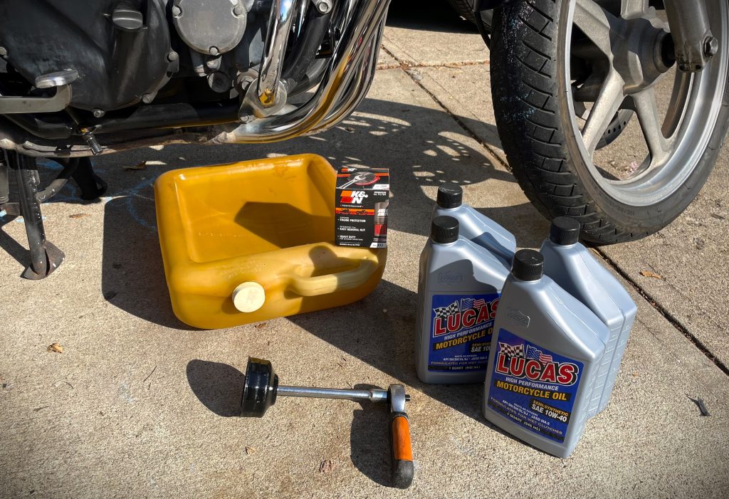 oil changing supplies near a motorcycle