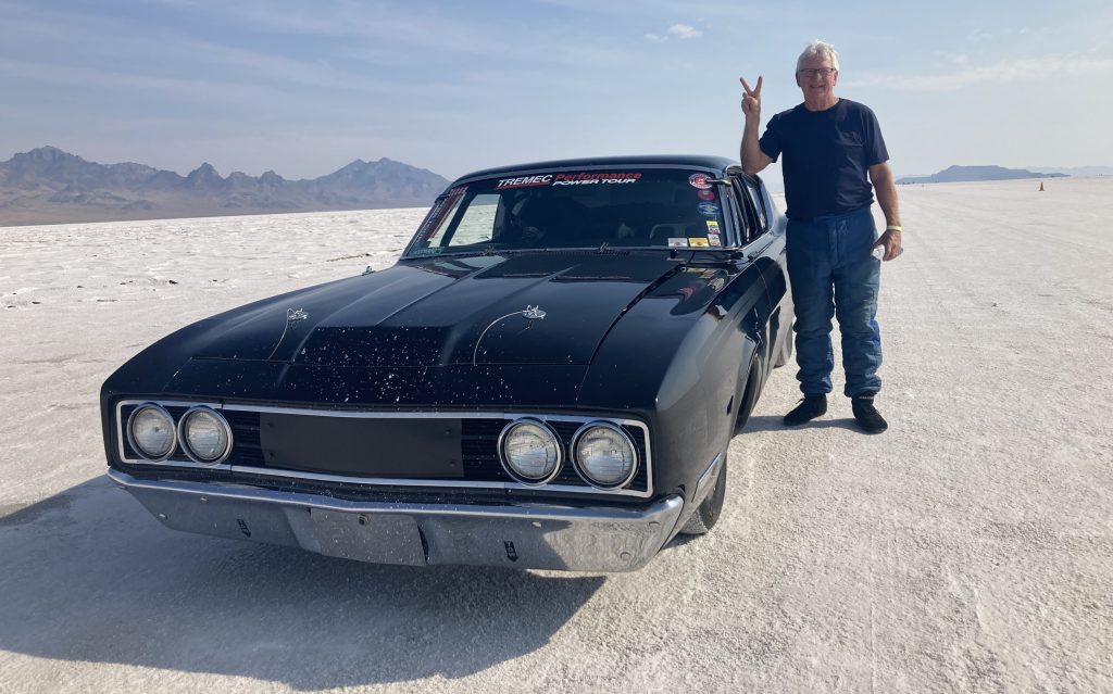 Man & a 1969 Mercury Cyclone Spoiler II at Bonneville salt flats
