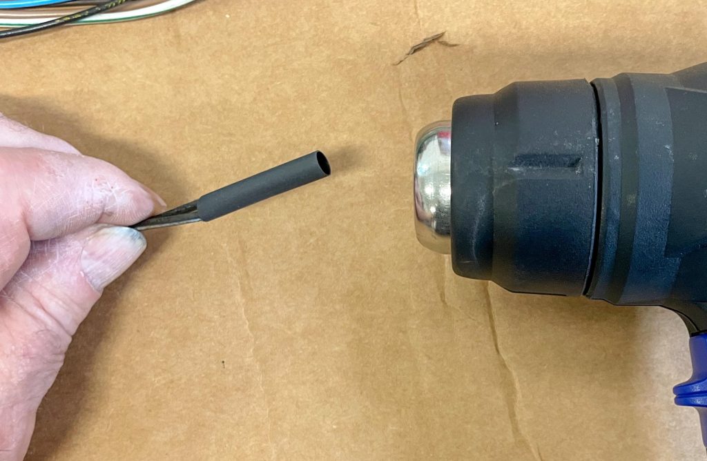 Using heat shrink to cover terminated wire