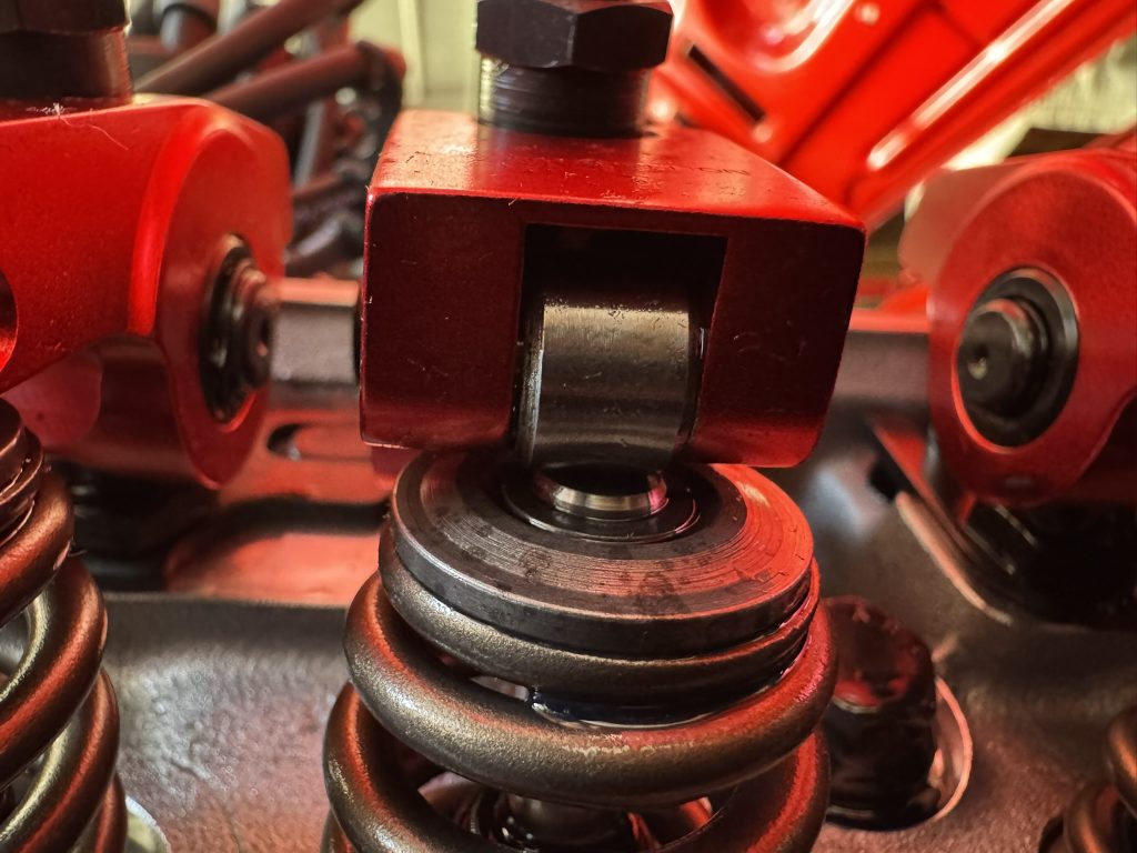 Close up of tip of a valve under a roller rocker arm