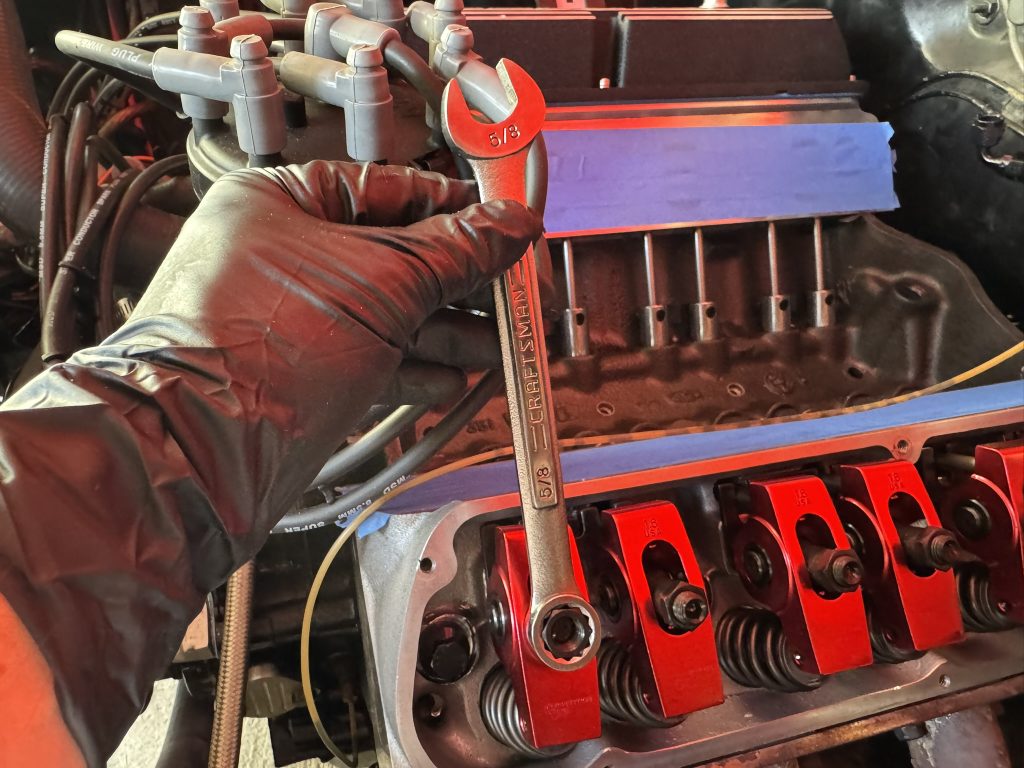 a wrench on a rocker arm adjustment nut