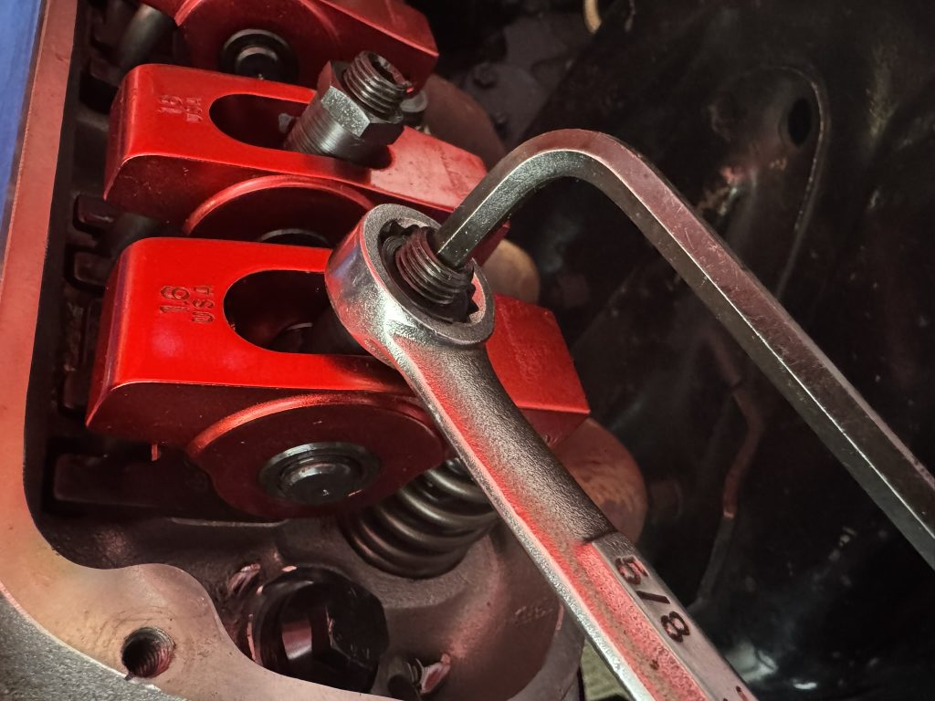 tightening a rocker arm down with allen wrench