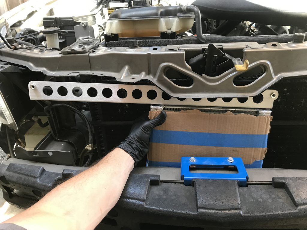 test fitting oil cooler bracket on a mustang