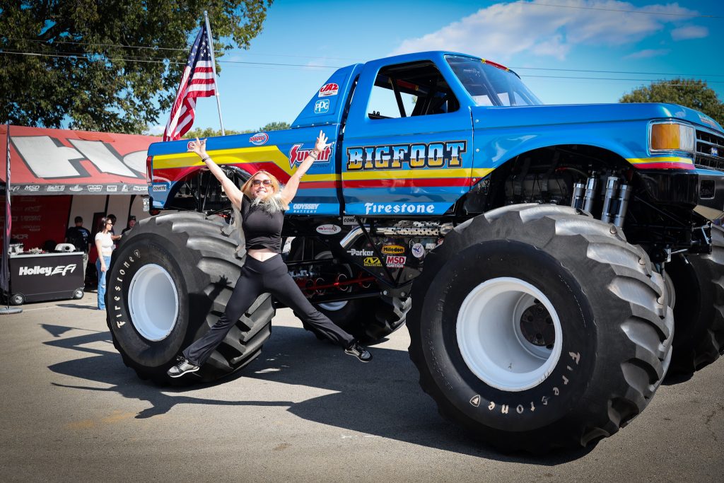 woman jumping in front of bigfoot monster truck