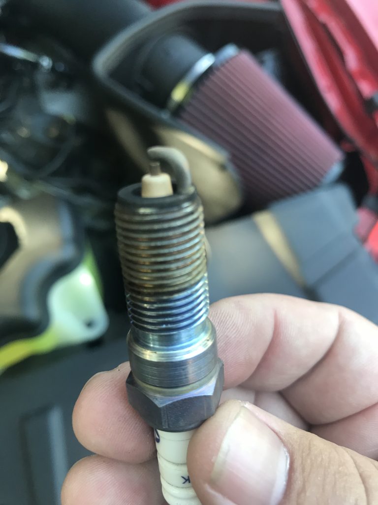 hand holding a used spark plug