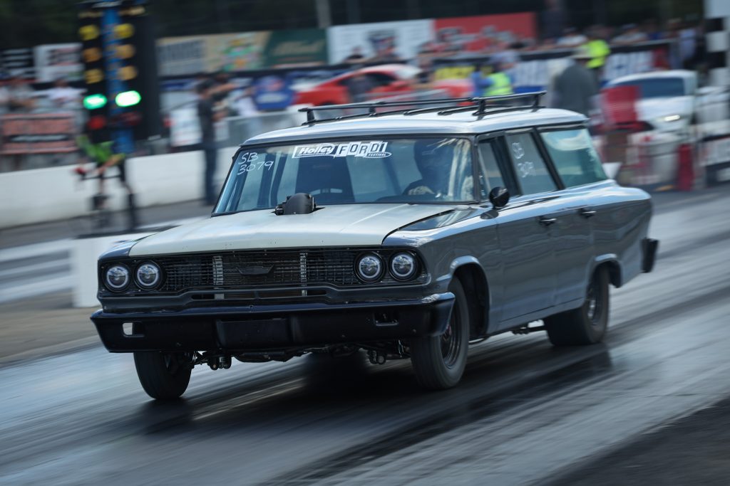 a vintage ford wagon on dragstrip