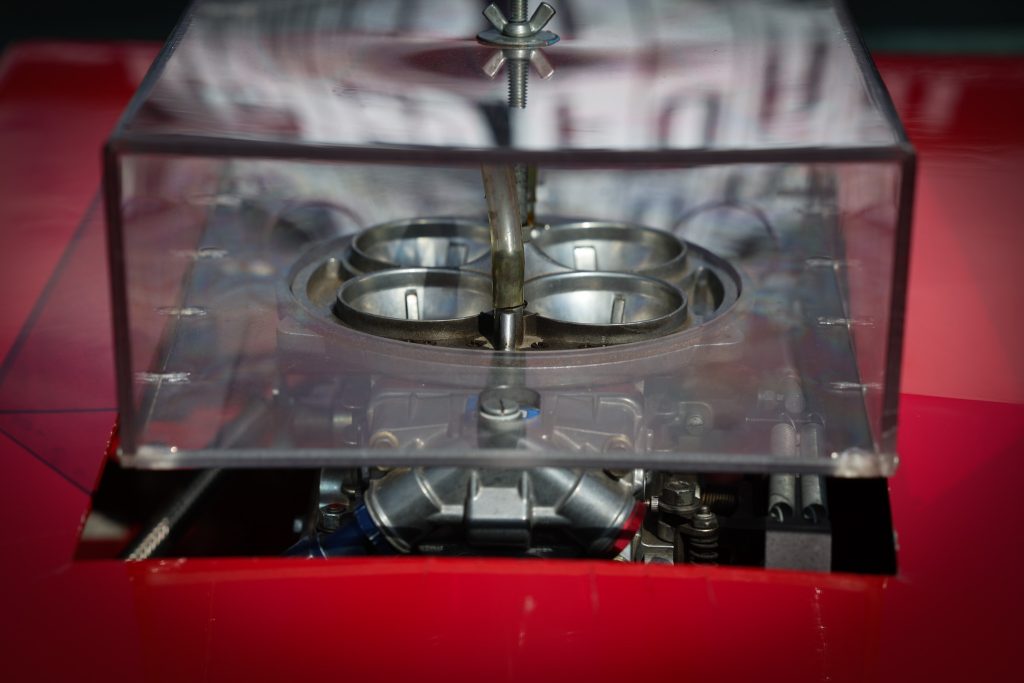 a carburetor under a clear mailbox style scoop