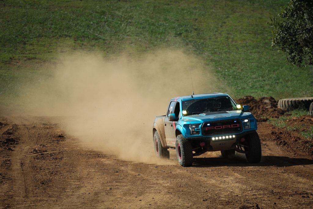 ford raptor race truck going down dirt track
