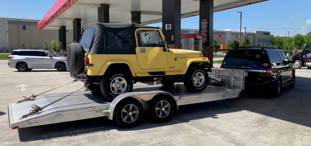 Jeep YJ Wrangler on trailer in gas station