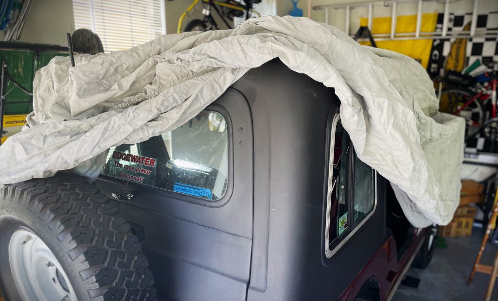 Jeep being fitted with a storage cover