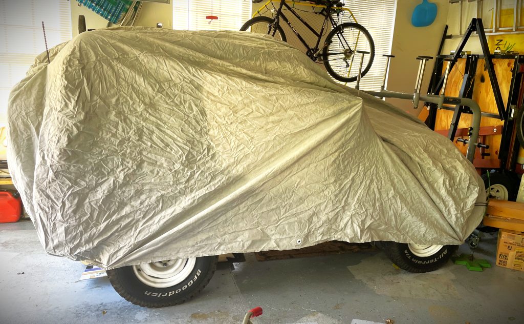 Old Jeep under a fitted Car Cover