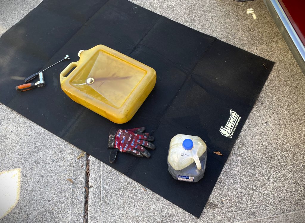 Oil change mat on ground with tools