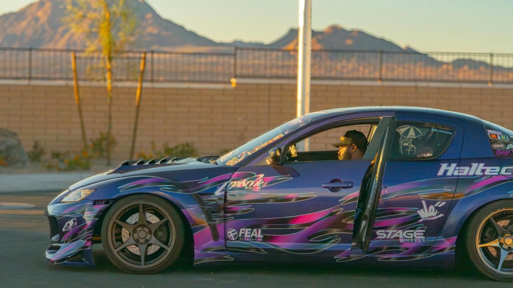 Man sitting in Mazda RX-8 drift car
