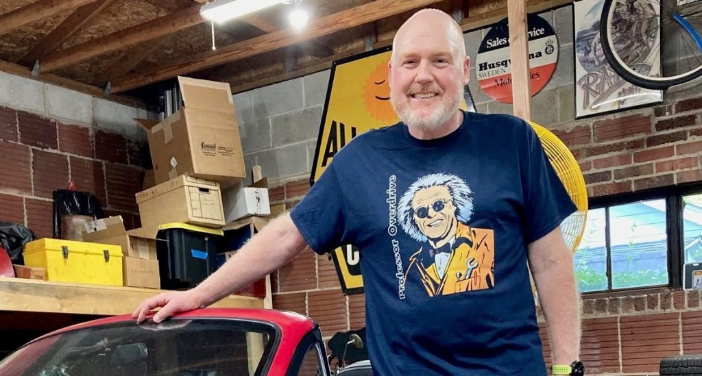 Man posing for photo in garage