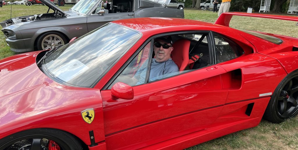 man sitting in a Ferrari f40