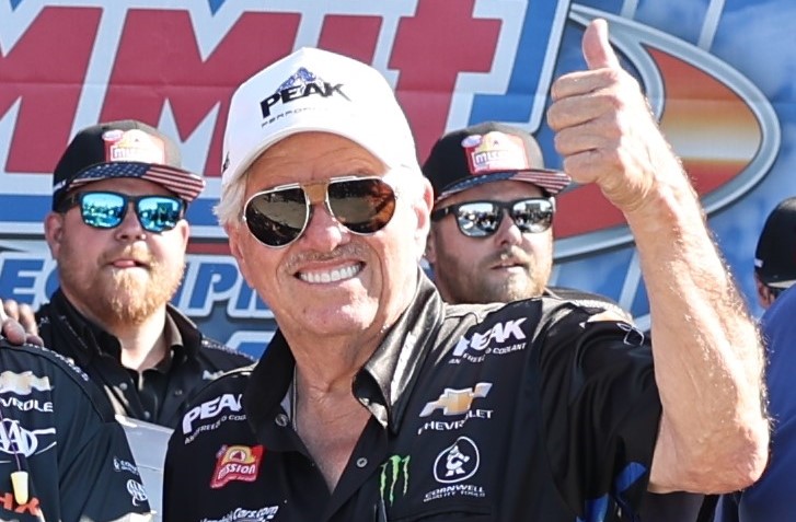 John Force giving a thumbs up during a race event
