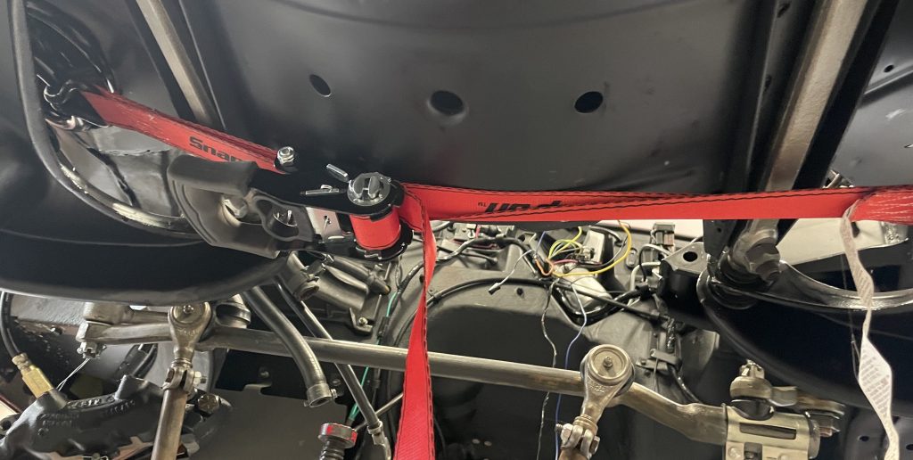 Using ratchet strap to secure front coil spring for removal