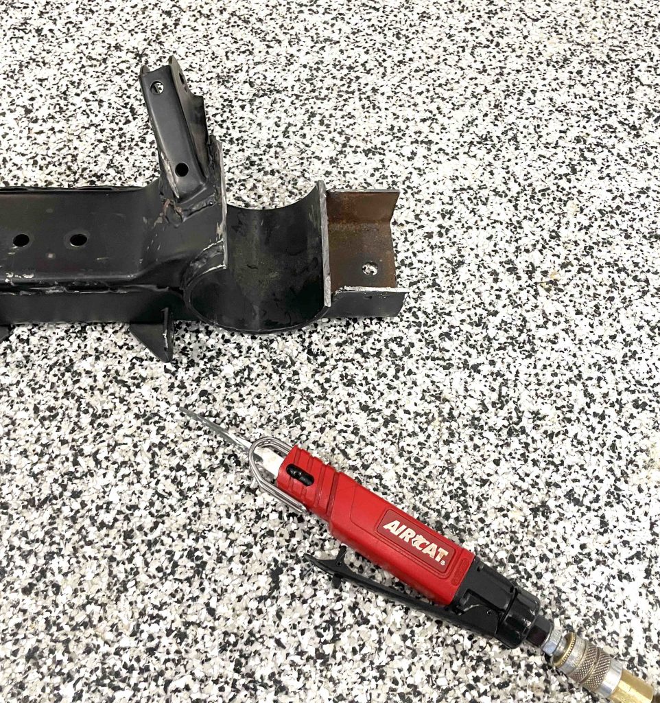 Piece of transmission crossmember cut out with an AIRCAT air saw