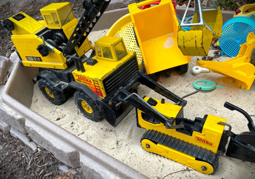 Tonka toy crane and front end loader in sandbox