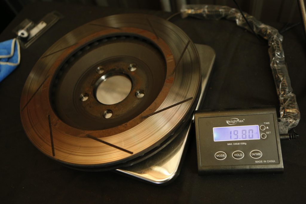old brake rotor placed on a weight scale