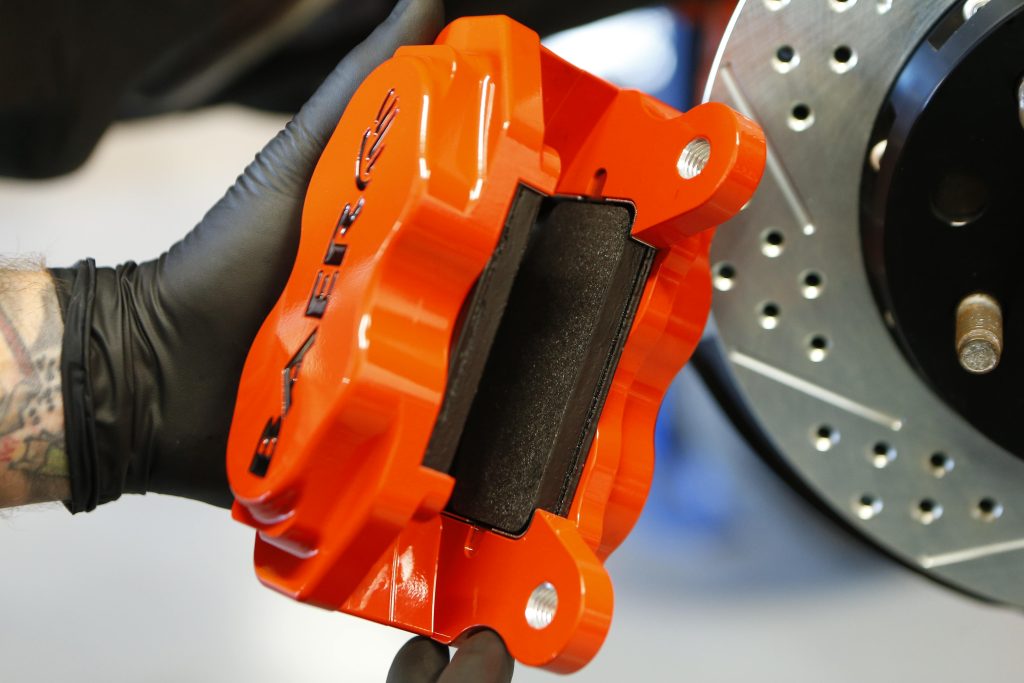 mechanic holding a brake caliper