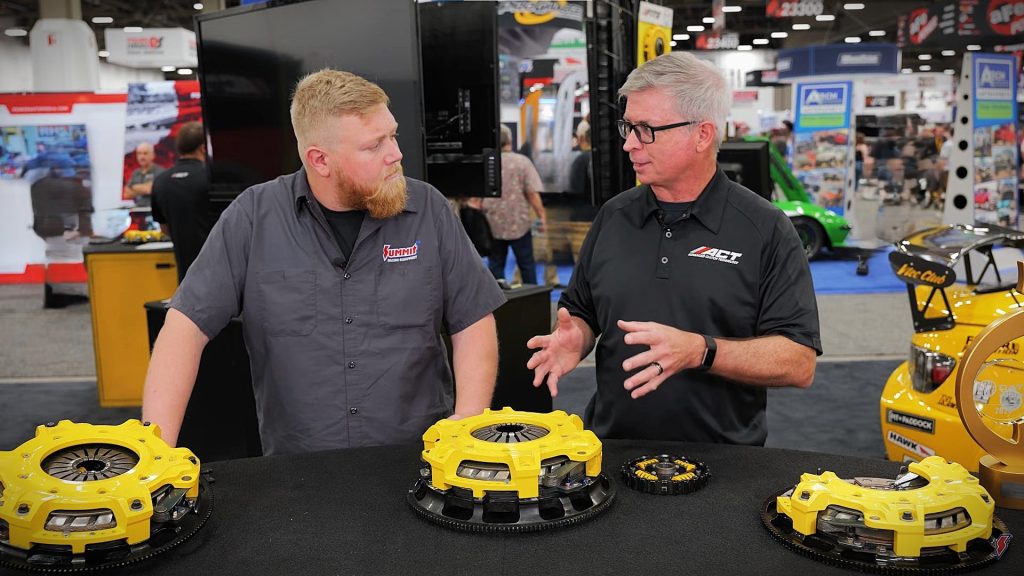 2 men behind a table at a trade show display