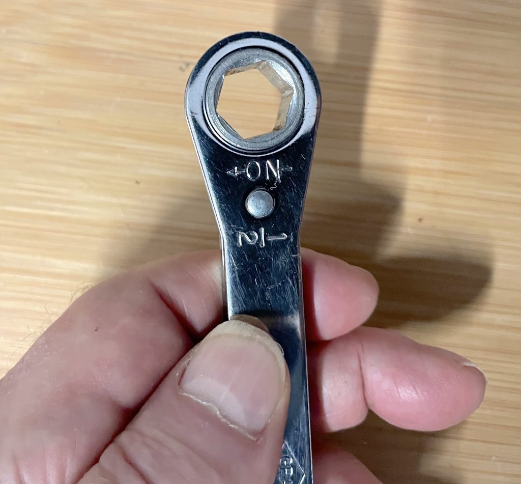 Ratcheting box end wrench with flip-over reverse mechanism