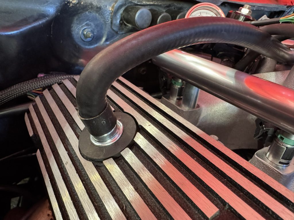 breather fitting installed in a valve cover